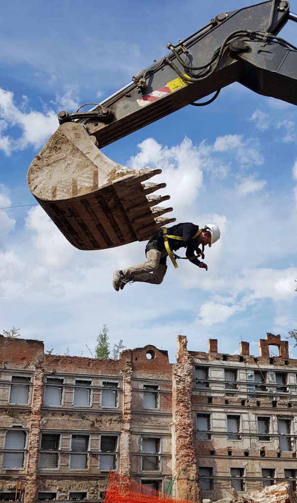 On the excavator hangs Oleg Surnov