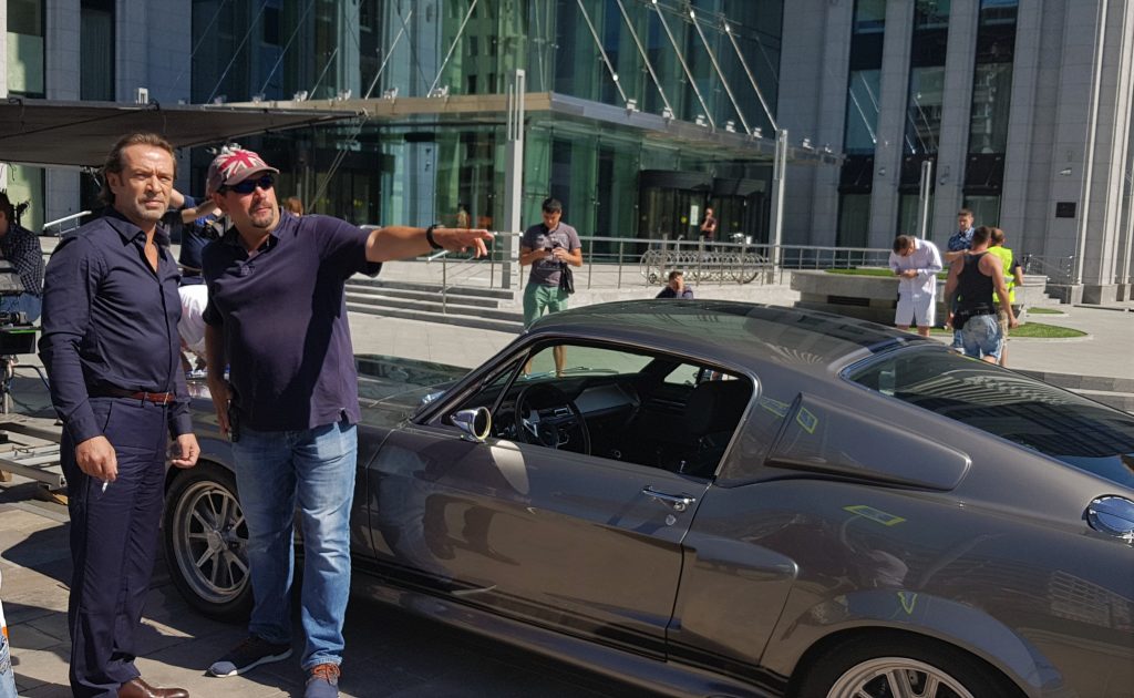 Actor Vladimir Mashkov and stunt coordinator Alexei Silkin discuss the car scene on the background of "Shelby GT500 Eleanor"